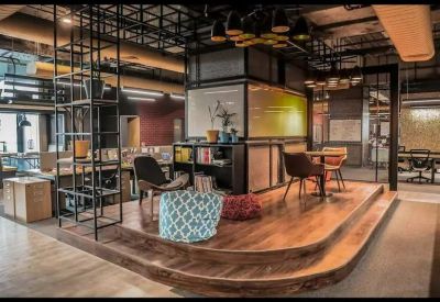 Sunlit breakout area with an elevated wooden floor and colorful bean bags