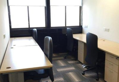 Private office suite with two wooden desks and large windows.