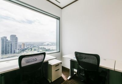 Dual desk private office with a large window overlooking the city skyline.