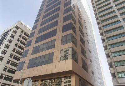 Exterior view of the towering glass and tan facade of the Al Ghaith Holding Tower.
