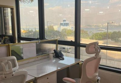 Close-up of a bright workstation with harbor views and decorative crystal lamps.