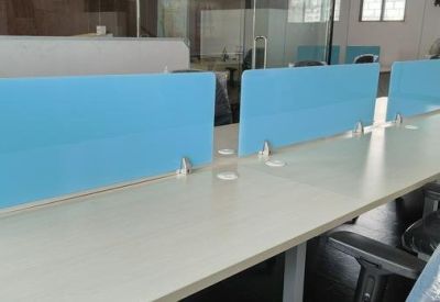 Bright open-plan workspace at 361 sterling arcade featuring white desks with blue privacy screens.
