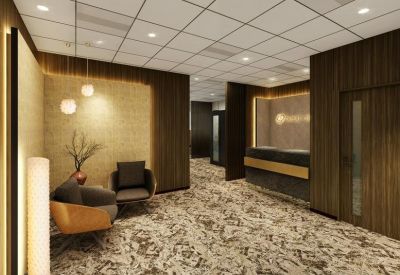 Modern reception area featuring dark wood paneling, a sleek front desk, and a patterned carpet.