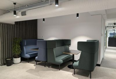 Semi-private high-back acoustic booths in blue and teal for quiet collaboration.