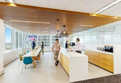 Spacious communal kitchen and breakout area with a large wooden dining table.