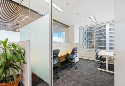 Private office suite with two workstations and floor-to-ceiling windows.