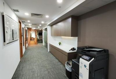 Long hallway at 8/F, Rykadan Capital Tower featuring a copy machine and built-in wooden cabinetry.