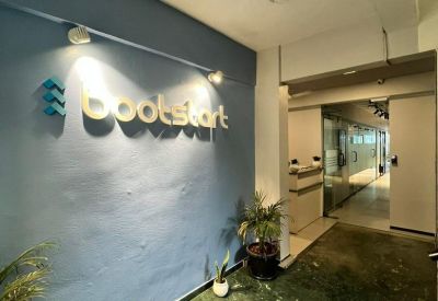 Branded reception area of the Arcadian Building with a blue feature wall and green marble floors.