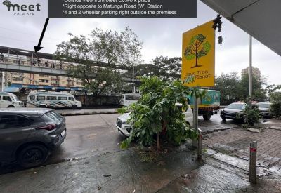 Street view outside the office showing local surroundings and a nearby railway footbridge.