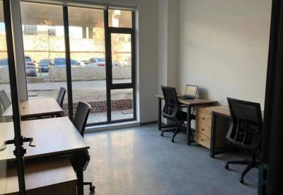 Three-person office suite with desks and chairs.
