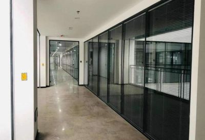 Corridor with glass partitions and polished floors.