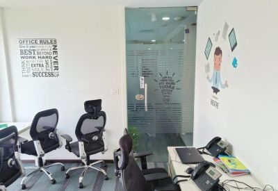 Small office suite with black ergonomic chairs, desks, and motivational wall decals.