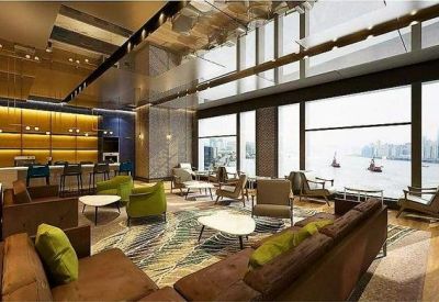 Spacious lounge with diverse seating and panoramic harbor views.