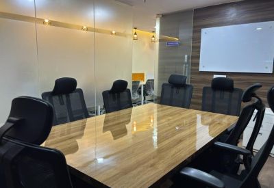 Professional meeting room with a large wooden table, black leather chairs, and a whiteboard.