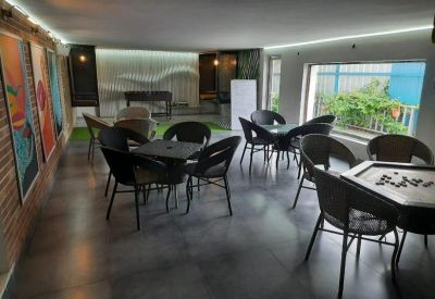 Modern breakroom featuring wicker seating and a carrom board game table.
