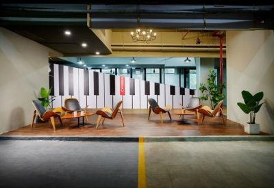 Lounge area with mid-century modern chairs and a large piano-key wall graphic.