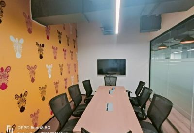 Meeting room featuring zebra-patterned wallpaper and a long conference table.