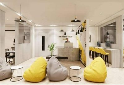 Bright reception lobby featuring comfortable bean bag seating and a minimalist front desk.