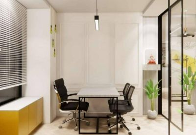 Private four-person office suite with a sleek grey table, black rolling chairs, and yellow accent cabinet.