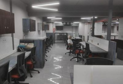 Long view of a professional coworking space with multiple rows of workstations.