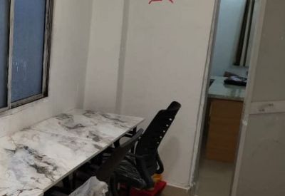 A two-person workstation with marble-patterned desks and a swastika symbol on the wall.
