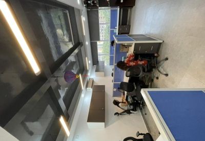 Professional workstation area featuring blue dividers and ergonomic office chairs.