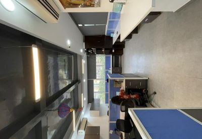 Modern office interior showing glass partitions, warm lighting, and organized cubicles.