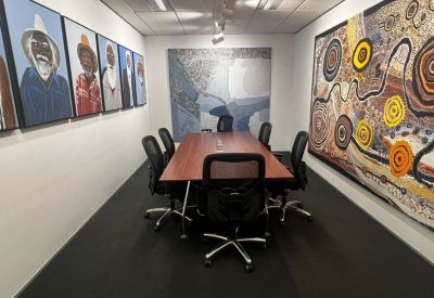 Small meeting room with indigenous artwork on walls.