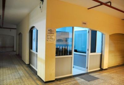 Office suite entrance with glass doors located in a brightly lit corridor.
