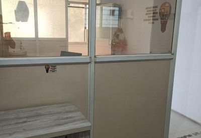 Office workspace at 257 Mankar Chowk Road with glass partitions and a wooden desk.
