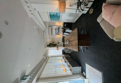 Meeting room with a long wooden table, black carpet, and modern art.
