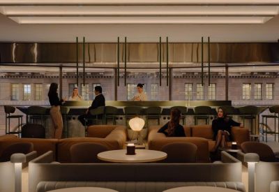 Plush communal lounge with bar seating and comfortable armchairs.