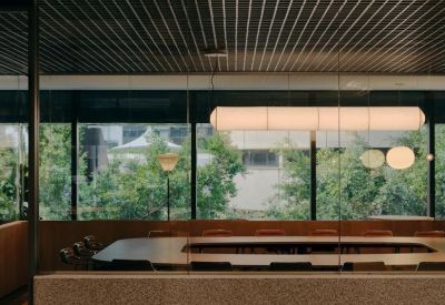 Spacious boardroom featuring a large table and expansive window views.