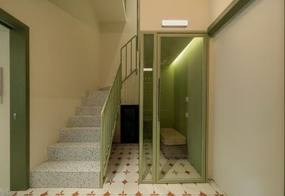 A stone staircase next to a glass-enclosed quiet booth with warm lighting.