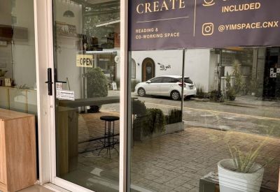 Glass storefront featuring the brand name and service inclusions on the window.