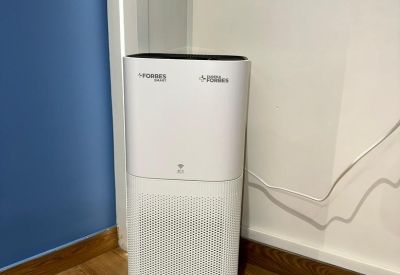 Private meeting nook with a round wooden table, four chairs, and a flat-screen TV.