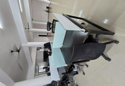 Close-up of workstations with adjustable chairs and light partition.