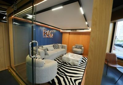 Glass-enclosed meeting room with modern furniture and zebra rug.