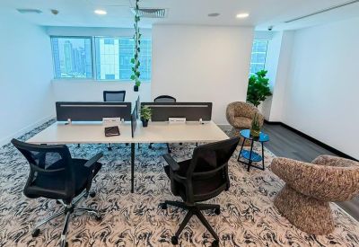 Bright coworking area with stylish patterned carpet and comfortable lounge seating.