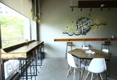 Bright communal break area with a wooden hexagonal table and motivational wall mural.