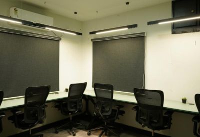 Open workspace with multiple office chairs and bright lighting.