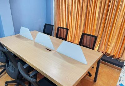 Close-up of a wooden conference table featuring frosted glass privacy panels.