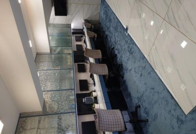 High-angle view of a long workspace row with ergonomic chairs and sleek desks.