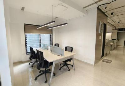 Four-person collaborative workstation with white tabletops and privacy screens.