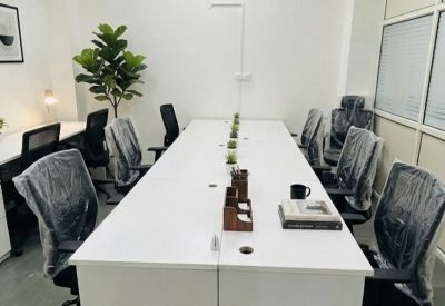 Tidy desk row with protective plastic on chairs and small potted succulents.