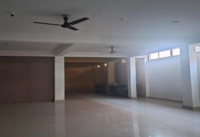 Spacious, white open-plan office area at Ranchi-Jamshedpur Road, Kokar, Ranchi, India with ceiling fans and natural light.