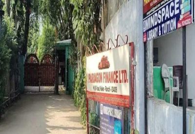 Entrance pathway with trees and signage for various businesses.