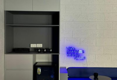 Storage cabinet and mini-fridge unit integrated into a communal seating area.