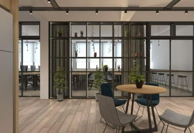 Lounge area with round wooden table, modern chairs, and glass partitions.