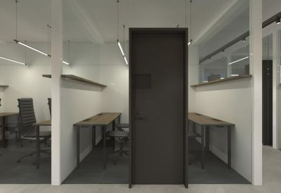 Private workstations separated by white partitions with minimalist pendant lighting.